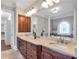 Elegant bathroom with dual sinks, and a soaking tub at 621 Champions Dr, Mcdonough, GA 30253