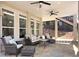 A covered outdoor patio area features comfortable seating and multiple ceiling fans for enjoying the outdoors at 621 Champions Dr, Mcdonough, GA 30253