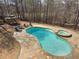 An aerial view of an in-ground swimming pool, spa, stone patio, and outdoor furniture at 621 Champions Dr, Mcdonough, GA 30253