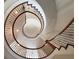 Stunning spiral staircase with wood treads and iron railing, creating an elegant focal point at 621 Champions Dr, Mcdonough, GA 30253