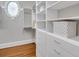 Bright walk-in closet with custom shelving and drawers at 621 Champions Dr, Mcdonough, GA 30253
