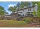Spacious backyard with a deck, screened porch, and mature trees for shade at 191 Gates Mill Dr, Lawrenceville, GA 30045