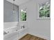 Bright bathroom featuring a soaking tub with a modern faucet and pendant lighting at 191 Gates Mill Dr, Lawrenceville, GA 30045