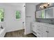 Bathroom with double sink vanity with a view of the bathtub and commode at 191 Gates Mill Dr, Lawrenceville, GA 30045