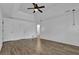 Spacious bedroom featuring a ceiling fan, tray ceiling, and hardwood floors at 191 Gates Mill Dr, Lawrenceville, GA 30045