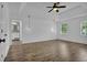Spacious bedroom with a tray ceiling, ceiling fan, hardwood floors, and bright light at 191 Gates Mill Dr, Lawrenceville, GA 30045