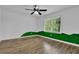 Bright bedroom featuring hardwood floors, a ceiling fan, and a double window offering natural light at 191 Gates Mill Dr, Lawrenceville, GA 30045