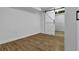 Bedroom featuring hardwood floors and a barn door at 191 Gates Mill Dr, Lawrenceville, GA 30045