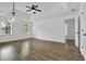 Spacious bedroom featuring a ceiling fan, tray ceiling, and hardwood floors at 191 Gates Mill Dr, Lawrenceville, GA 30045