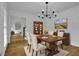 Elegantly staged dining room with wood table and chairs, and hardwood floors at 191 Gates Mill Dr, Lawrenceville, GA 30045