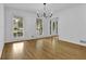 Dining area with pristine white walls, large windows, and gleaming hardwood floors at 191 Gates Mill Dr, Lawrenceville, GA 30045