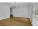 Spacious room featuring gleaming hardwood floors and a hanging light fixture at 191 Gates Mill Dr, Lawrenceville, GA 30045