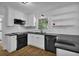 Renovated kitchen featuring stainless appliances, sleek countertops, and modern white cabinetry at 191 Gates Mill Dr, Lawrenceville, GA 30045