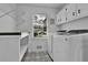 Well-lit laundry room with patterned tile floors, washer, and dryer at 191 Gates Mill Dr, Lawrenceville, GA 30045