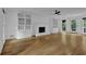 Bright living room boasts hardwood floors, fireplace, built-in bookshelves, and natural light at 191 Gates Mill Dr, Lawrenceville, GA 30045