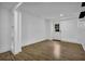 Living room with hardwood floors, shiplap walls, and white door at 191 Gates Mill Dr, Lawrenceville, GA 30045