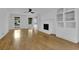 Bright living room with wood floors, a fireplace, built-in bookshelves, and ceiling fan at 191 Gates Mill Dr, Lawrenceville, GA 30045