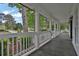Inviting covered porch featuring classic railing, and dark stained decking at 191 Gates Mill Dr, Lawrenceville, GA 30045