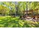 Backyard oasis with outdoor fireplace, a charming pergola, a hammock, and lush greenery at 1919 Edinburgh Ne Ter, Atlanta, GA 30307