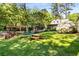 Lush green backyard features a hammock, picnic table, pergola, and mature trees perfect for outdoor enjoyment at 1919 Edinburgh Ne Ter, Atlanta, GA 30307