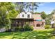 Backyard with a screened porch, a brick patio, and mature trees offering shade at 1919 Edinburgh Ne Ter, Atlanta, GA 30307
