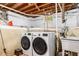 Unfinished basement featuring laundry area with washer, dryer, utility sink and exposed ceiling at 1919 Edinburgh Ne Ter, Atlanta, GA 30307