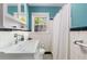 Updated bathroom with modern fixtures, a window with backyard view, and a classic tile shower at 1919 Edinburgh Ne Ter, Atlanta, GA 30307