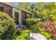 Close up of a charming home's entrance framed by greenery and blossoming red roses at 1919 Edinburgh Ne Ter, Atlanta, GA 30307