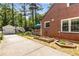 Brick house has a white detached garage, raised garden beds, and a charming blue umbrella on back deck at 1919 Edinburgh Ne Ter, Atlanta, GA 30307