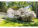 Detached garage with blooming flowers, lush lawn, and ample storage space at 1919 Edinburgh Ne Ter, Atlanta, GA 30307
