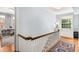 Hallway featuring wood floors and natural light from the window at the top of the stairs at 1919 Edinburgh Ne Ter, Atlanta, GA 30307