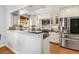 Bright kitchen features white cabinets, stainless steel appliances, subway tile backsplash, and granite countertops at 1919 Edinburgh Ne Ter, Atlanta, GA 30307