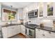 Updated kitchen with white cabinets, stainless steel appliances, granite countertops, and subway tile backsplash at 1919 Edinburgh Ne Ter, Atlanta, GA 30307