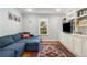 Comfortable living room with built-in shelving, a large window, and a cozy blue sectional sofa at 1919 Edinburgh Ne Ter, Atlanta, GA 30307