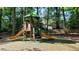 A colorful playground set with slides is located next to a wooded area at 1919 Edinburgh Ne Ter, Atlanta, GA 30307
