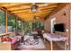 Screened in porch featuring wood ceiling, ceiling fans, and comfortable seating for outdoor enjoyment at 1919 Edinburgh Ne Ter, Atlanta, GA 30307