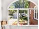 Window view overlooking the lush backyard garden and a detached garage at 1919 Edinburgh Ne Ter, Atlanta, GA 30307