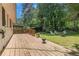 Spacious backyard featuring a wooden deck, fire pit, and well manicured lawn at 2920 Appling Dr, Atlanta, GA 30341