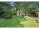 Backyard featuring a large lawn, patio seating, and detached garage at 2920 Appling Dr, Atlanta, GA 30341