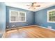 Bedroom featuring hardwood floors, two windows and a ceiling fan at 2920 Appling Dr, Atlanta, GA 30341