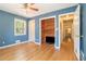 Bedroom with hardwood floors, ceiling fan and a built-in entertainment center at 2920 Appling Dr, Atlanta, GA 30341