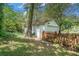 Detached garage with a roll up door, traditional door, and picket fence at 2920 Appling Dr, Atlanta, GA 30341