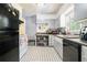 Functional kitchen features black appliances, black and white tile flooring, and ample storage at 2920 Appling Dr, Atlanta, GA 30341