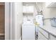Utility room featuring a washing machine, water heater, and minimal storage at 2920 Appling Dr, Atlanta, GA 30341