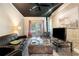 Living room with a black ceiling, exposed brick, and access to outdoor patio at 2920 Appling Dr, Atlanta, GA 30341