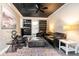 Living room featuring unique black ceiling, exposed brick wall, and built in shelving at 2920 Appling Dr, Atlanta, GA 30341