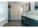 Bathroom featuring double sinks, a soaking tub, and a walk-in shower at 6757 Delaware Bnd, Fairburn, GA 30213