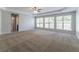 Large carpeted bedroom with tray ceilings and plenty of natural light at 6757 Delaware Bnd, Fairburn, GA 30213