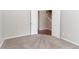 Cozy carpeted bedroom with double doors and freshly painted walls and white trim at 6757 Delaware Bnd, Fairburn, GA 30213