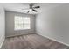 Cozy bedroom featuring a ceiling fan and large window at 6757 Delaware Bnd, Fairburn, GA 30213
